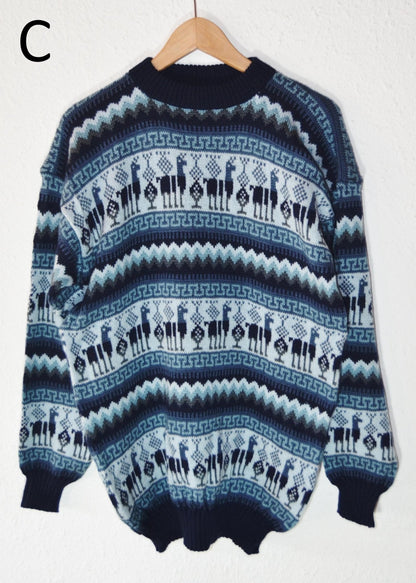 Handmade alpaca sweater with blue and white geometric and floral patterns, ribbed cuffs and hem.