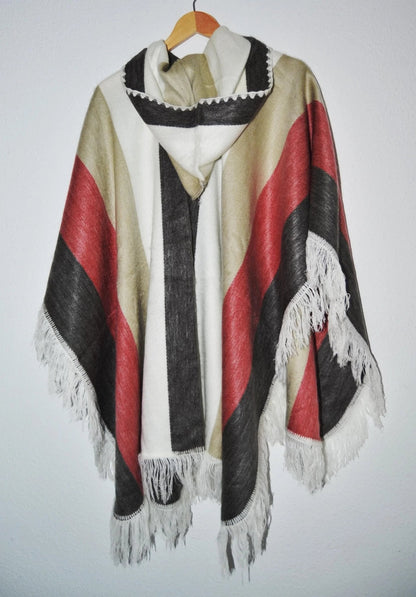 Handmade alpaca wool hooded poncho with red, black, and beige stripes and fringe trim.