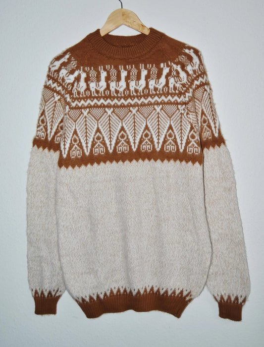 Handmade alpaca sweater in brown and cream with geometric and animal patterns.