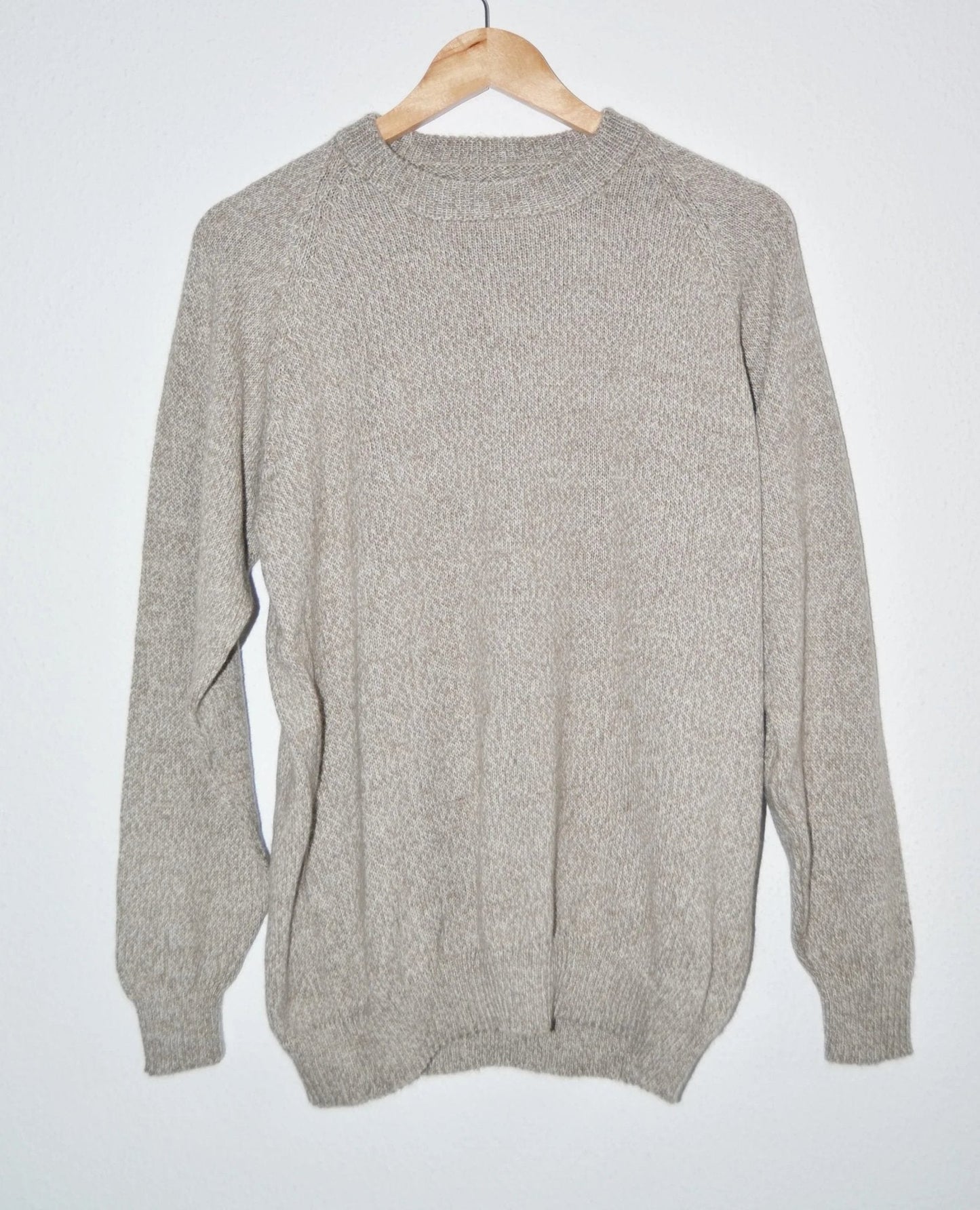 Handmade alpaca wool sweater in soft beige with long sleeves and ribbed cuffs and hem.