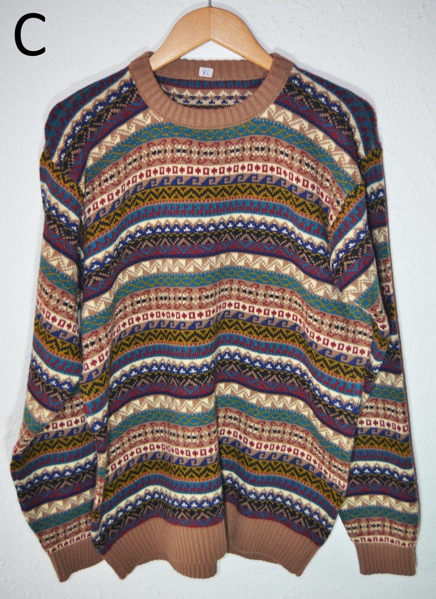 Handmade alpaca sweater with multicolor horizontal stripes and brown ribbed cuffs and collar.