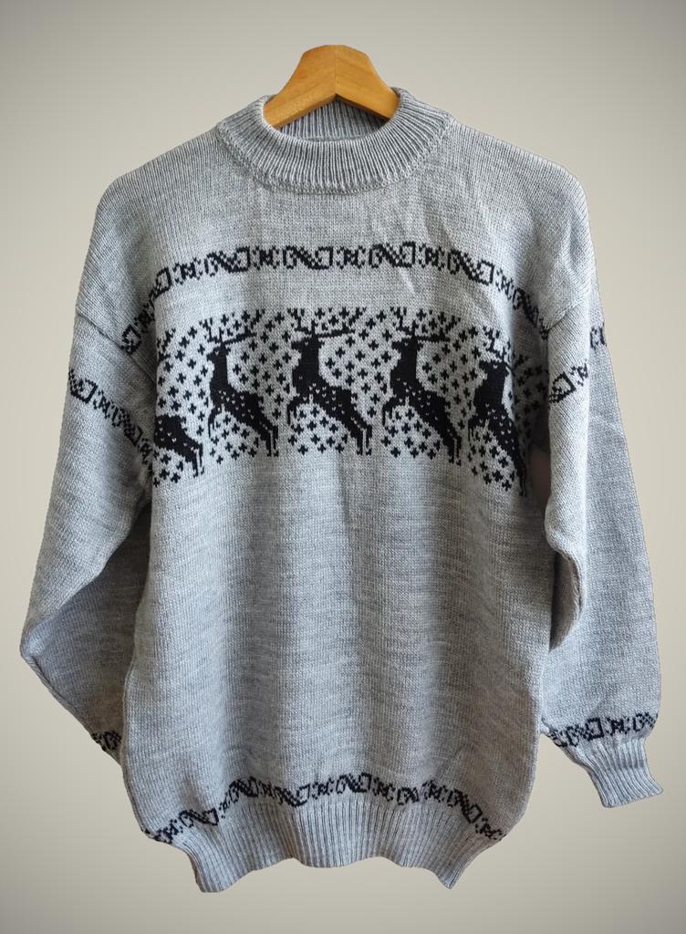 Handmade gray alpaca wool sweater with black reindeer and geometric patterns.