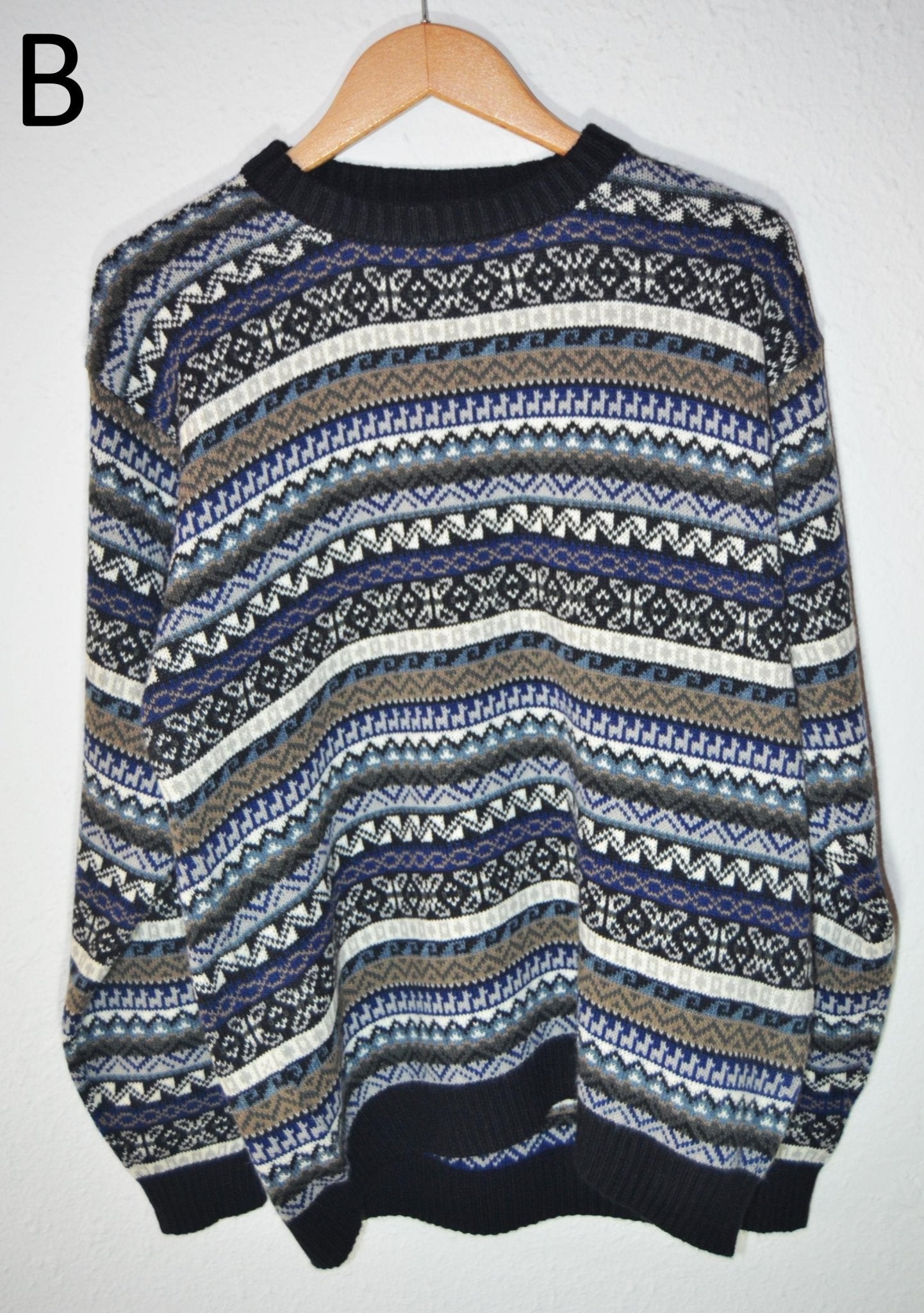 Handmade alpaca wool sweater with blue, gray, and cream intricate patterns, ribbed cuffs and hem.