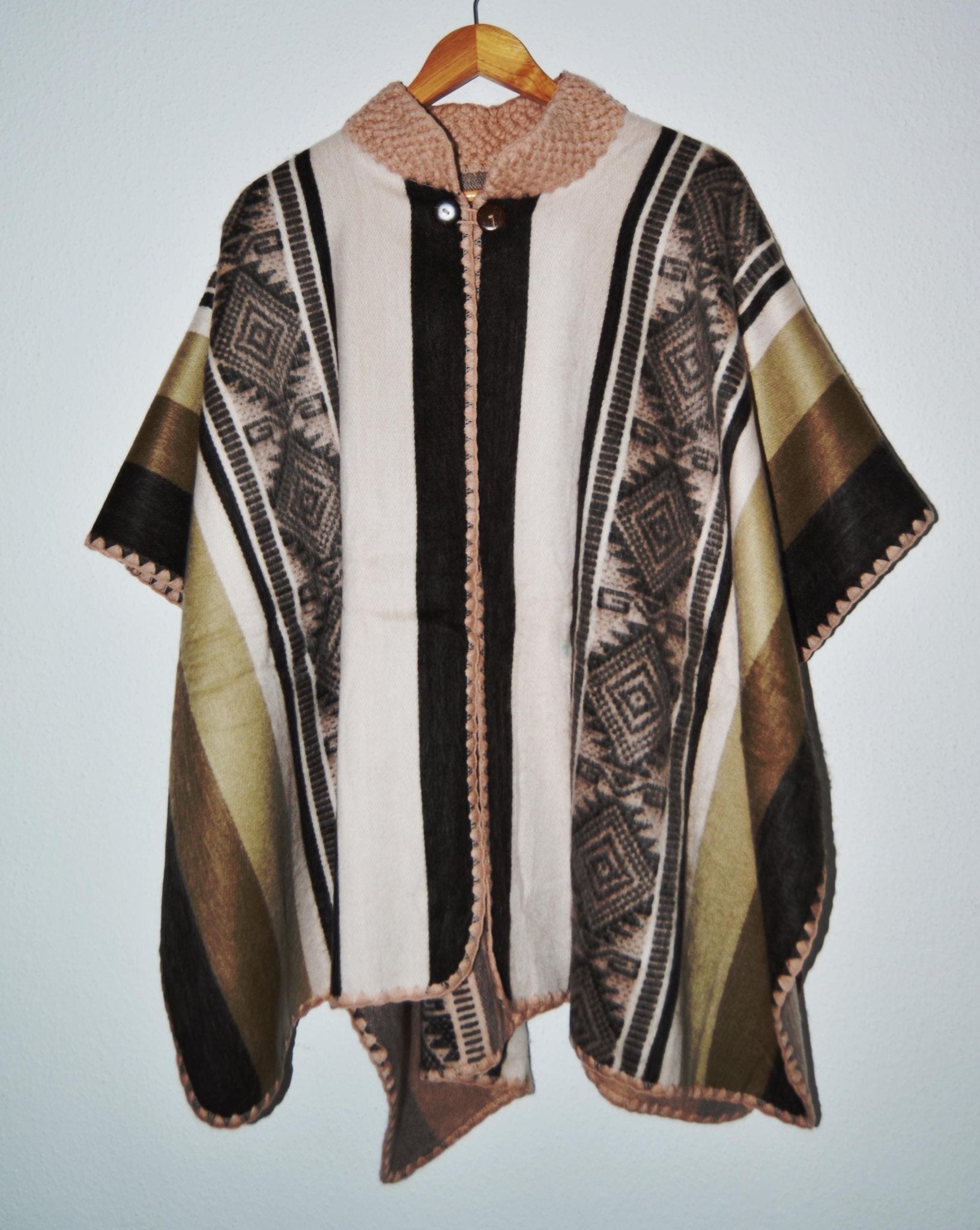 Handmade alpaca wool poncho in beige, brown, and black with geometric patterns and front ties.
