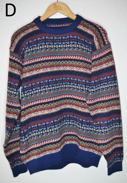 Handmade alpaca sweater with blue, pink, and cream geometric stripes, ribbed cuffs and hem.
