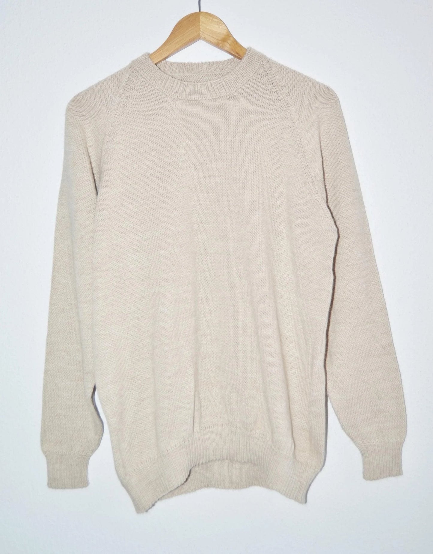 Handmade creamy beige alpaca wool sweater with a classic crew neck and ribbed cuffs.