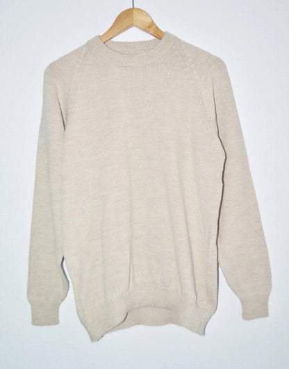 Handmade creamy beige alpaca wool sweater with a classic crew neck and ribbed cuffs.