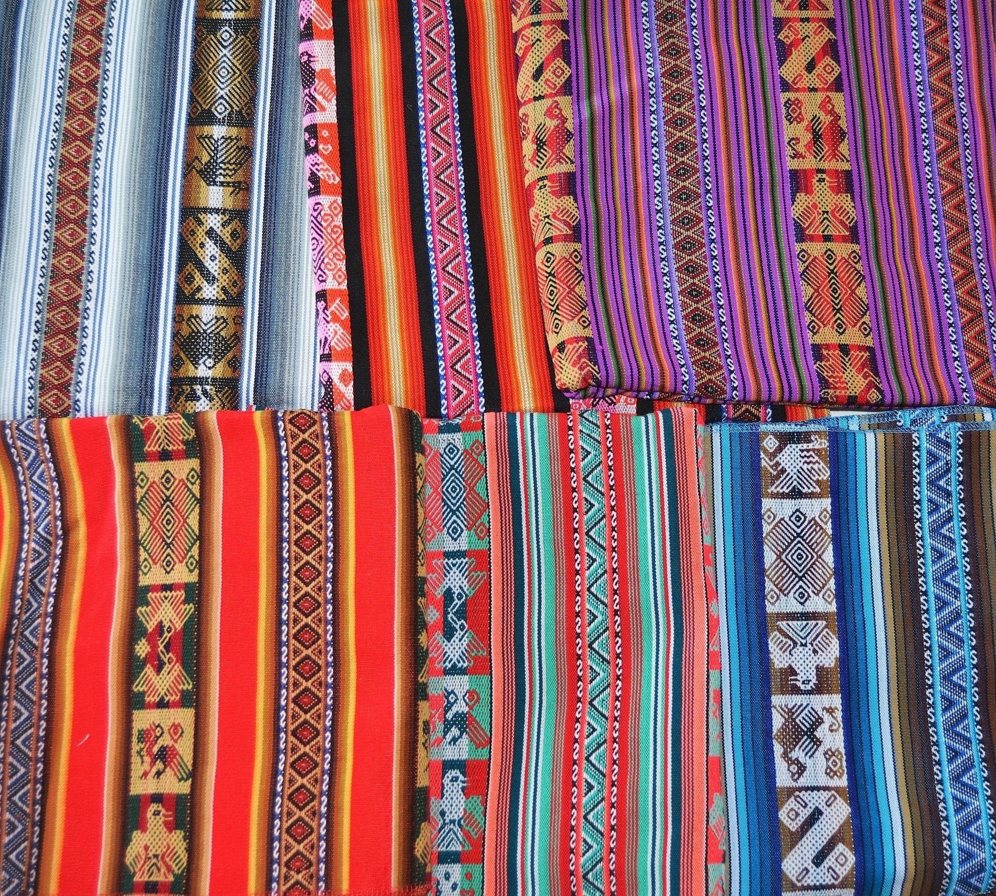 Colorful handmade alpaca blankets with traditional Andean geometric patterns in red, purple, orange, blue, green, white, and .