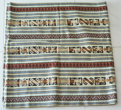 Handmade Peruvian alpaca blanket with intricate earthy brown and cream geometric patterns.