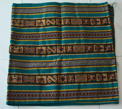 Handmade alpaca fabric with green, brown, and yellow traditional Andean patterns and geometric designs.