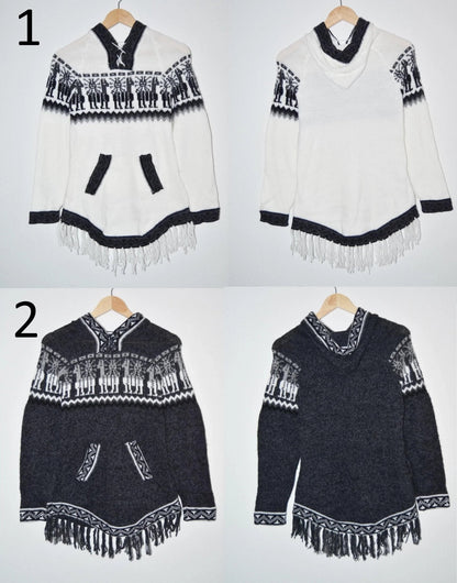 Handmade alpaca sweater with black and white geometric patterns, V-neck, and front pockets.