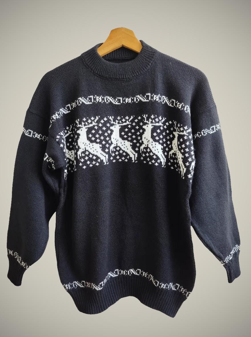 Handmade black alpaca sweater with white reindeer and snowflake pattern, crew neck.
