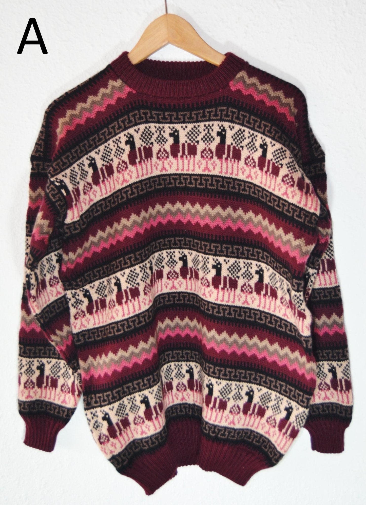 Handmade alpaca sweater with burgundy, pink, and cream geometric and llama patterns.