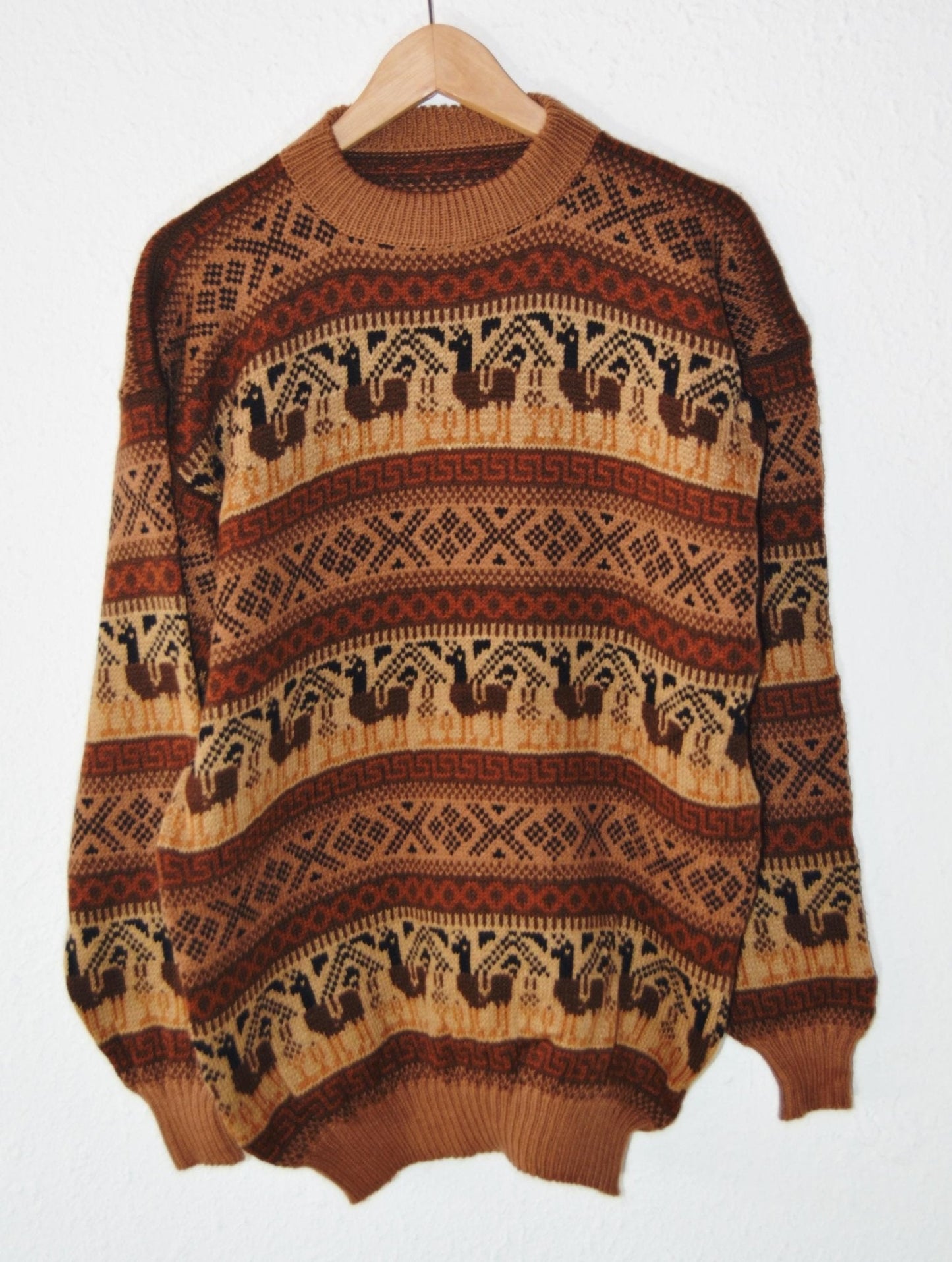 Handmade alpaca sweater with brown and beige geometric and animal patterns, wide fit.