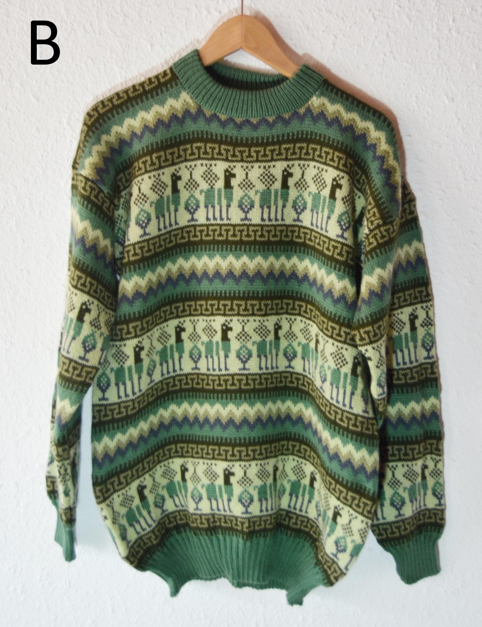 Handmade alpaca wool sweater with green, beige, and brown geometric and floral patterns.
